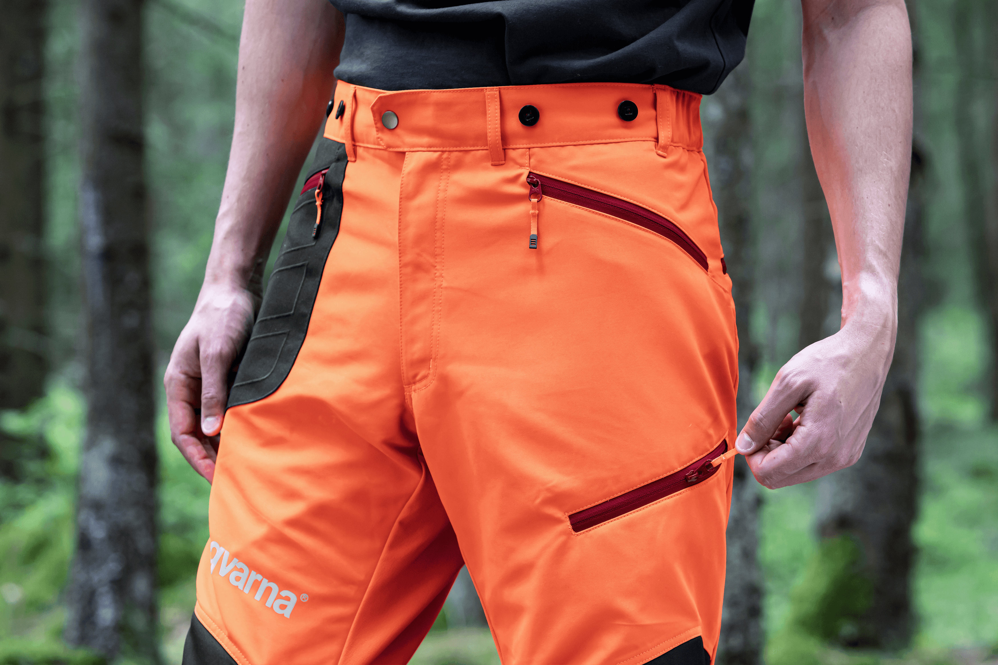 man holding chainsaw whilst cutting tree
